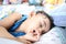 An adorable indian baby with one tooth sleeping with finger in mouth