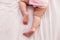 Adorable innocent baby try to crawling on bed that the first time infant baby crawl. Lovely toddler girl wear pink baby dress.