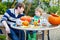 Adorable kid boy and his father making jack-o-lantern for hallo