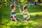 Adorable kid boy making fire on paper with a magnifying glass outdoors, on sunny day.