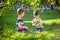 Adorable kid boy making fire on paper with a magnifying glass outdoors, on sunny day