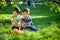 Adorable kid boy making fire on paper with a magnifying glass outdoors, on sunny day