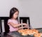 Adorable kid girl separate packing baked pork sausage