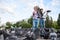 Adorable kids boy and girl, feeding rock pigeons crowding the street with discarded food in the city square