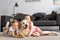 adorable kids hugging golden retriever dog while sitting on floor