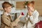 Adorable kids in love, boy make proposal to redhead girl