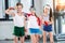 Adorable kids in sportswear smiling and posing at fitness studio