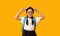 Adorable Korean Schoolgirl Holding Book On Head Posing, Studio Shot