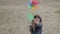 Adorable Latin girl playing with paper fan and catching wind