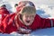 Adorable laughing boy at the snow background