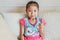 Adorable little Asian child girl happy making mini heart sign by thumb and forefinger