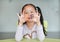 Adorable little Asian child girl holding alphabet EF Executive Functions text on her face. Education concept