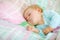 Adorable little baby girl sleeping in bed. Calm peaceful child dreaming during day sleep. Beautiful baby in parents bed