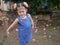 Adorable little baby girl smiling and making cute pose for outdoor photo shoot