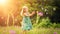 Adorable little blond girl having fun playing with soap bubbles