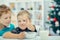 Adorable little blond kids eating cereals for breakfast or lunch.