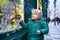 Adorable little boy looking through the window at Christmas decoration in the shop