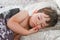 Adorable little boy sleeping in bed. Cute caucasian kid dreaming cuddly dreams