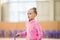 Adorable little girl athletes train in rhythmic gymnastics hall