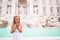 Adorable little girl background Trevi Fountain, Rome, Italy. Happy toodler kid enjoy italian vacation holiday in Europe.