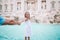 Adorable little girl background Trevi Fountain, Rome, Italy. Happy toodler kid enjoy italian vacation holiday in Europe.