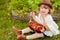 Adorable little girl with the basket full of stawberry