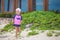 Adorable little girl in beautiful swimsuit walking