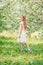 Adorable little girl in blooming apple garden on beautiful spring day