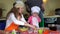 Adorable little girl with chef hat and her young parents preparing cookies