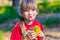 Adorable little girl drinking lemonade with straw