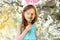 Adorable little girl eating colorful gum candies on Easter