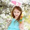 Adorable little girl eating colorful gum candies on Easter