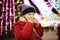 Adorable little girl eating waffle covered with chocolate icing on traditional Christmas market.