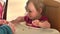 Adorable little girl eats spaghetti by herself for the first time, 4K