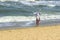 An Adorable Little Girl Enjoying On The Beach. Young Girl Looking At The Calming Beach View.