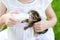 Adorable little girl feeding small kitten with kitten milk from the bottle