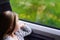 Adorable little girl going on vacations and traveling by railway.