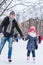 Adorable little girl and happy father on skating