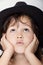 Adorable little girl in the hat closeup portrait