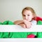 Adorable little girl having fun in twin bunk bed