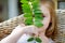 Adorable little girl hiding behind a leaf