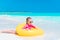 Adorable little girl with inflatable rubber circle splashing. Kid having fun on summer active vacation