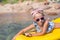 Adorable little girl kayaking in blue sea during