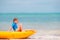 Adorable little girl kayaking during summer vacation