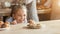 Adorable little girl looking at cookies with desire