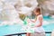 Adorable little girl looking at touristic map near Trevi Fountain, Rome, Italy. Happy toodler kid enjoy italian vacation