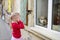 Adorable little girl met friendly dog behind a window