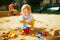 Adorable little girl on playground in sandpit