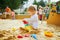 Adorable little girl on playground in sandpit