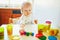 Adorable little girl playing with modelling clay